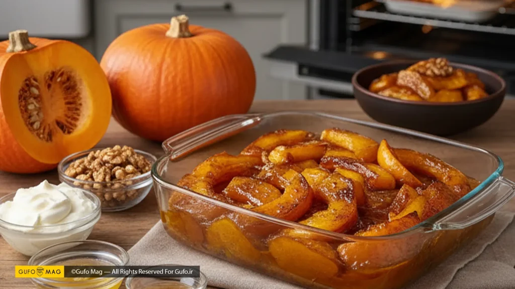 دسر کدو حلوایی در ظرف پیرکس داخل فر در آشپزخانه، همراه با مواد اولیه