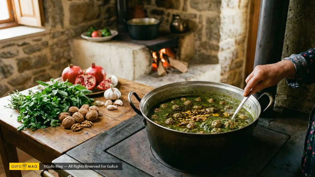 مادربزرگ گیلانی در حال همزدن خورش اناربیج روی اجاق هیزمی سنتی